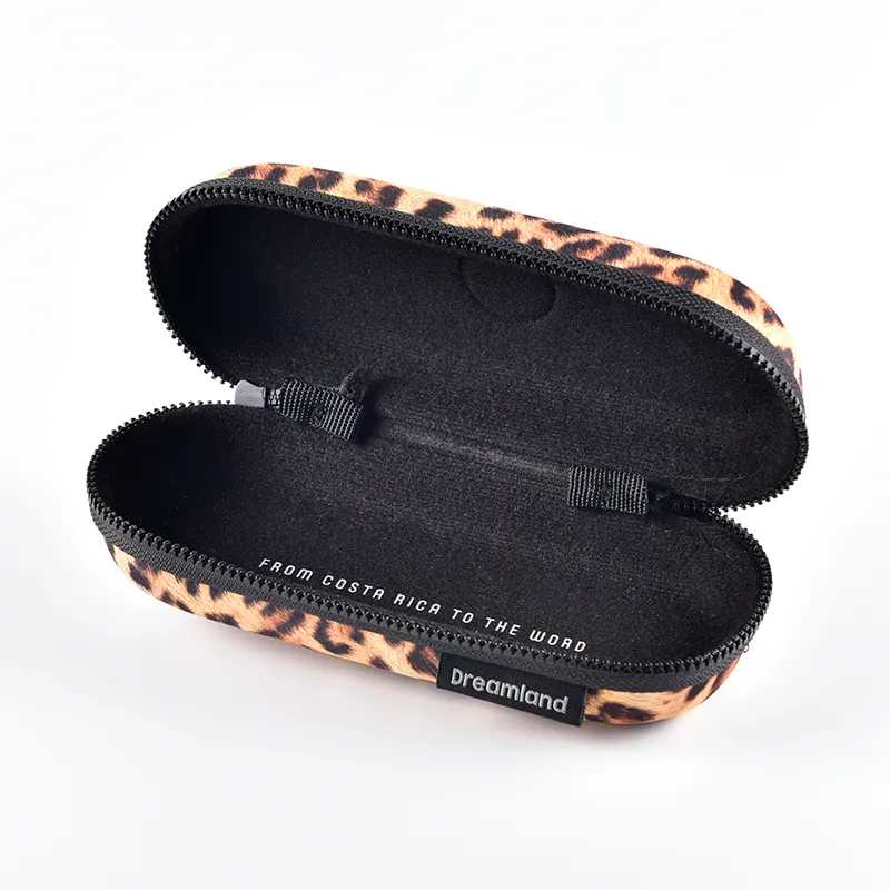 Inside view of a zipper eyeglass case showing black fabric lining and custom woven brand label