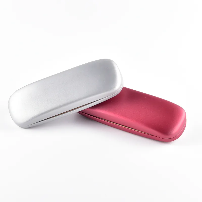 Hard shell clamshell eyeglass cases in metallic silver and rose finishes, closed