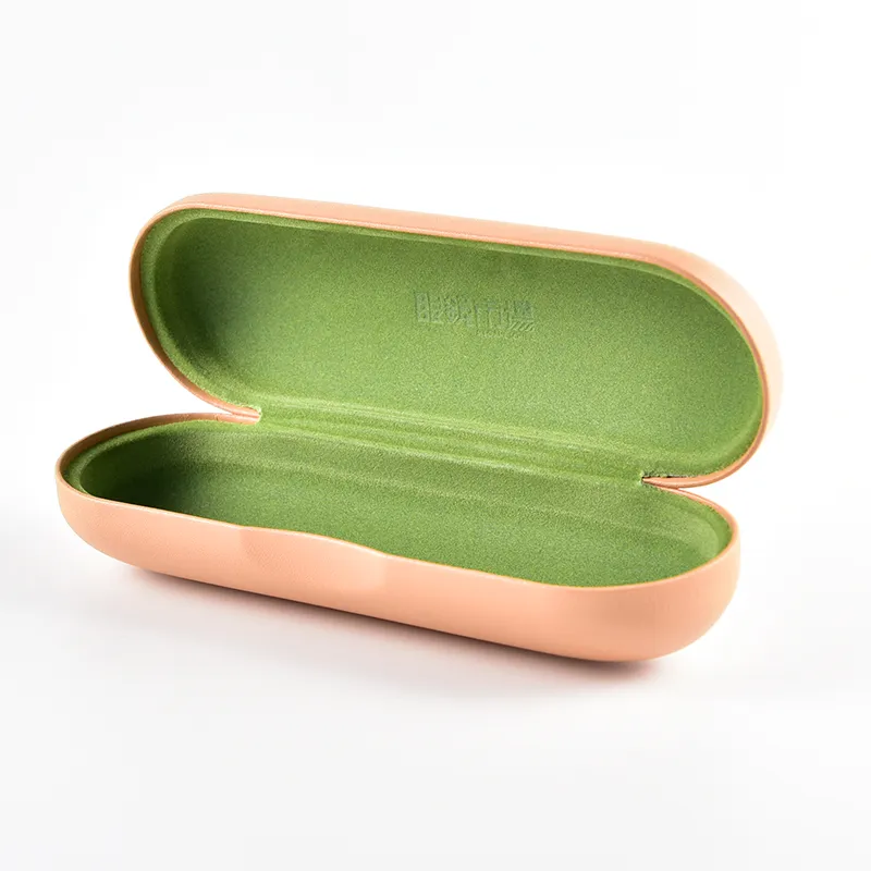 Interior detail of oval rose gold eyeglass case with branded green velvet lining