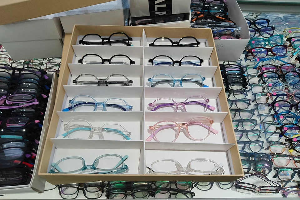 12 pair of TR90 glasses in drawer on the eyewear display table.