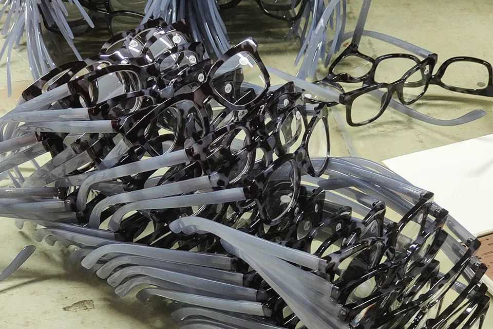 Stacked tortoise shell reading glasses with clear grey arms.