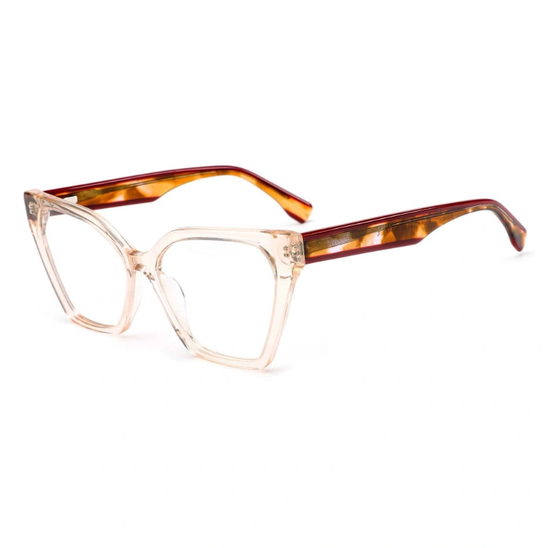 A three-quarter view of cat-eye eyeglasses with a translucent champagne-colored frame and reddish-brown tortoiseshell temples.