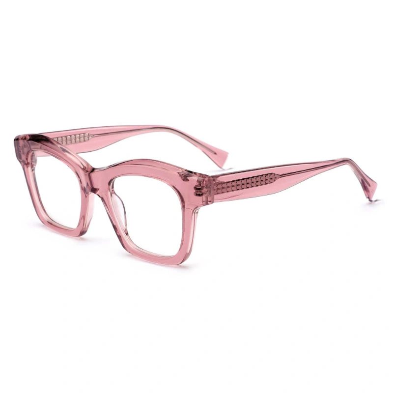 A pair of chunky, square acetate eyeglass frames in a translucent crystal pink, shown from a 3/4 angle. The decorative metal core wire is visible through the temples.
