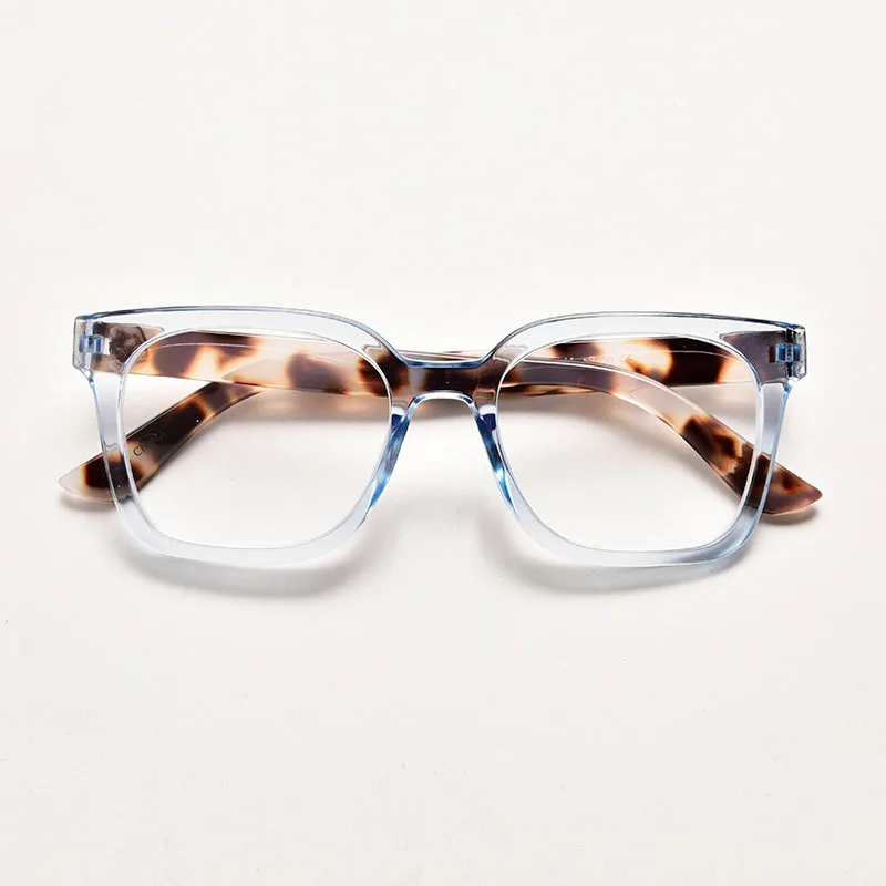 Transparent crystal blue square reading glasses featuring contrasting brown tortoiseshell arms and stylish thick frames.