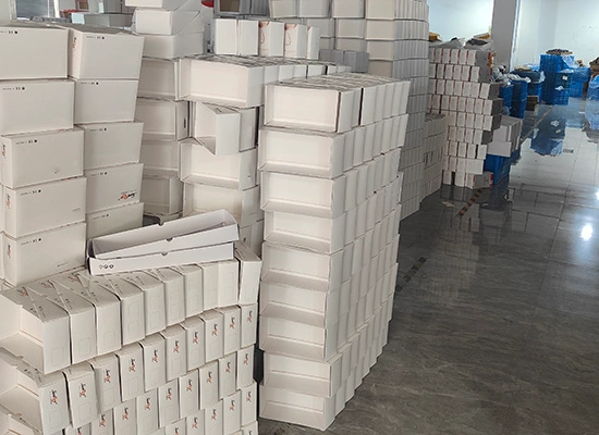 Wholesale eyewear packing boxes stacked in a factory warehouse ready for bulk packing.
