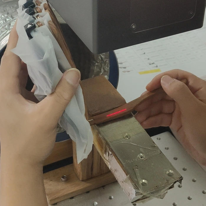 Laser engraving process for custom logo branding on eyewear frames at the factory.