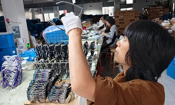 Vistalumo worker check quality lenses of eyeglasses.