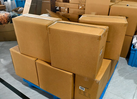 Sturdy corrugated export cartons stacked on a pallet, ensuring safe shipment for wholesale eyewear.