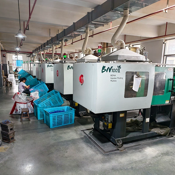 Row of high-precision injection molding machines at the eyewear factory for mass production of plastic frames.