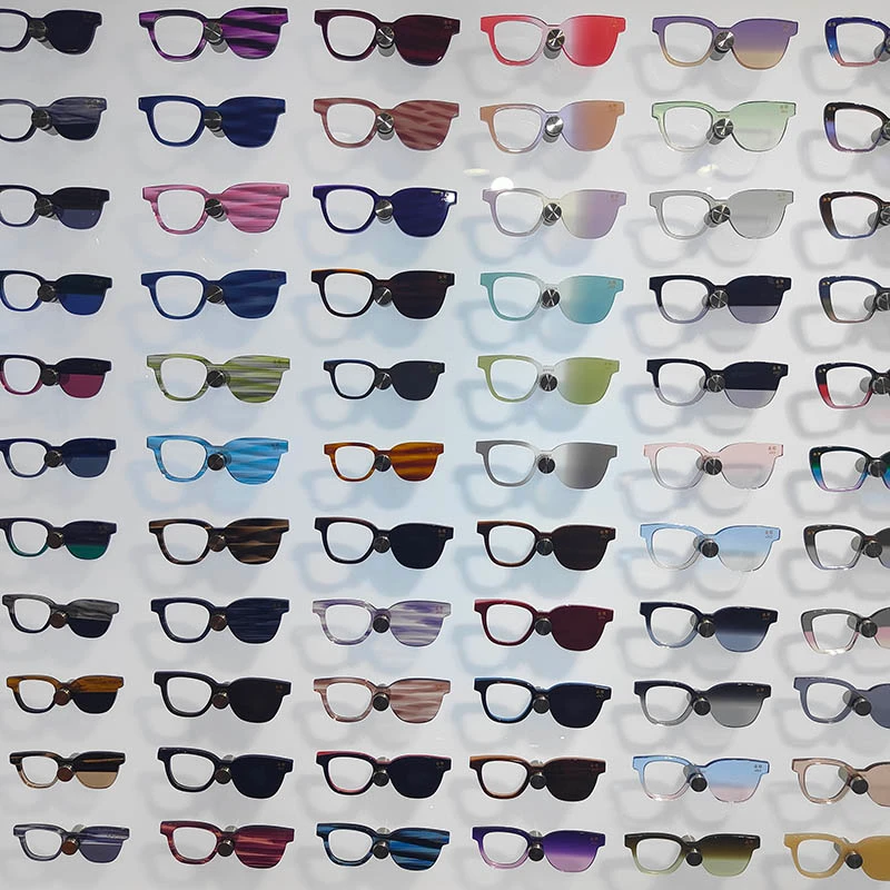 Factory showroom display featuring a vast collection of colorful acetate glasses frames, showcasing diverse patterns and lens options for wholesale.