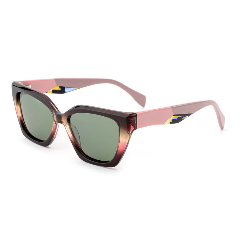 a pair of red frame acetate sunglasses with laminated temples.