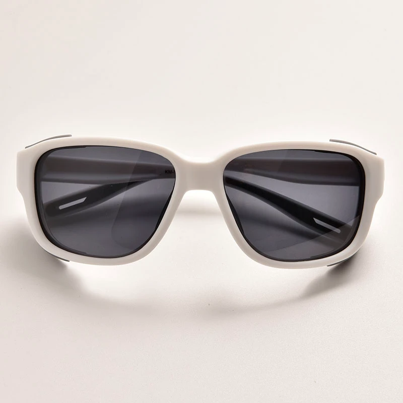 Front-angle view of a pair of black and grey sunglasses for hiking.