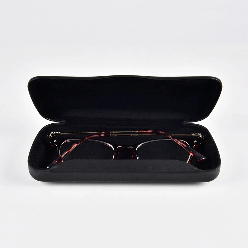 a black color triangular hard-shell eyeglass case hold a pair of reader glasses.