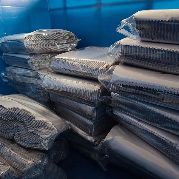 Neatly folded and stacked black microfiber cleaning cloths, showcasing final product quality and readiness for bulk packaging.