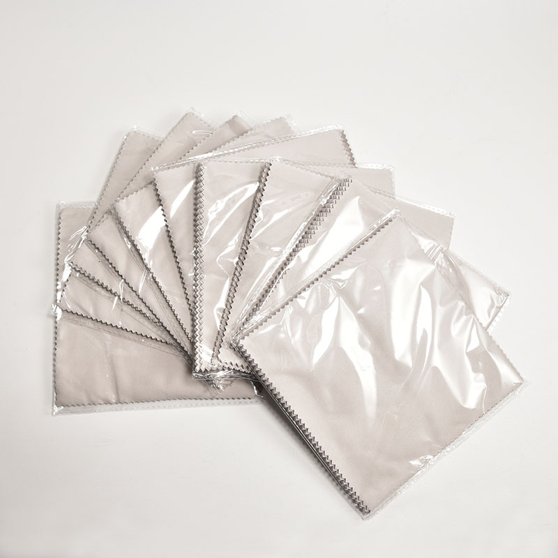 A complete eyewear care kit showing a custom glasses cleaning cloth in a poly bag.