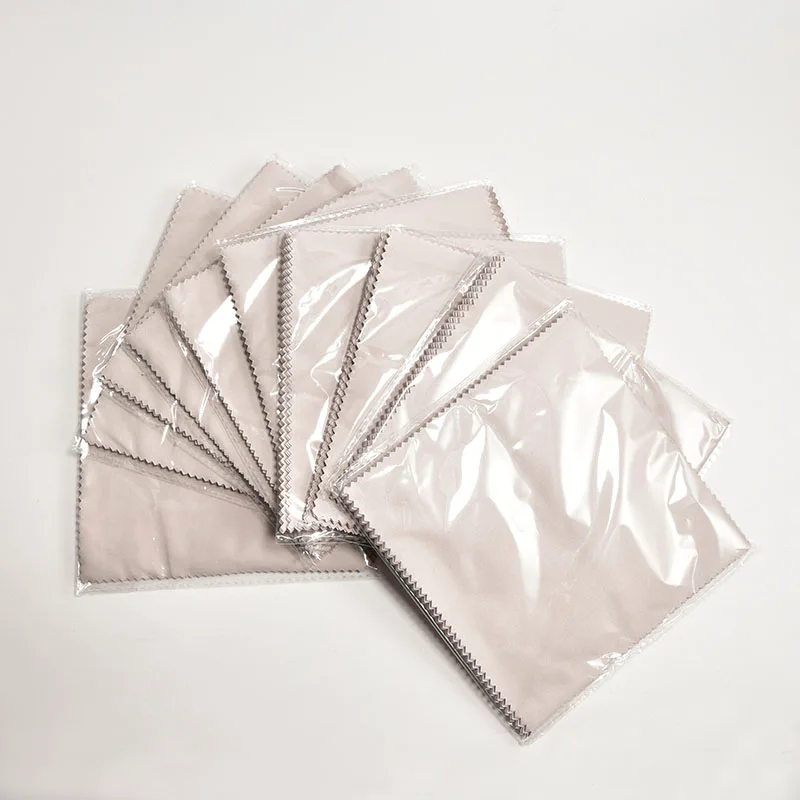 A complete eyewear care kit showing a custom glasses cleaning cloth in a poly bag.