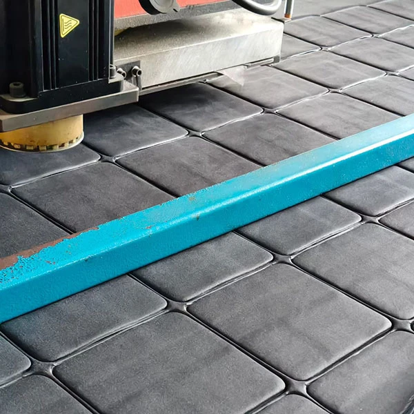 Mass production of black microfiber cleaning cloths with decorative serrated edges.