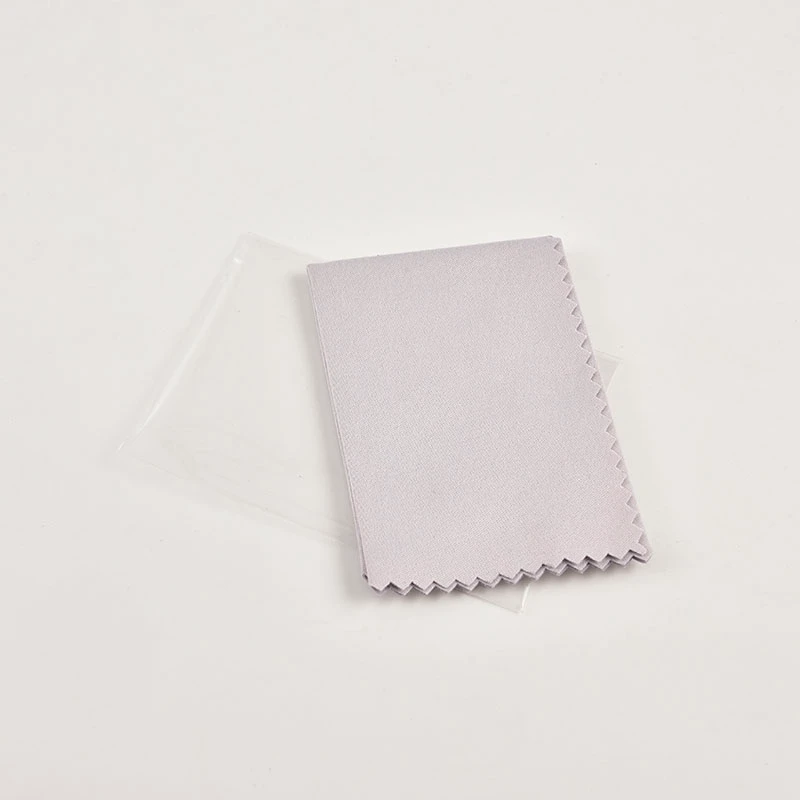 A close-up view showing the soft texture of a premium microfiber cleaning cloth in ivory color.